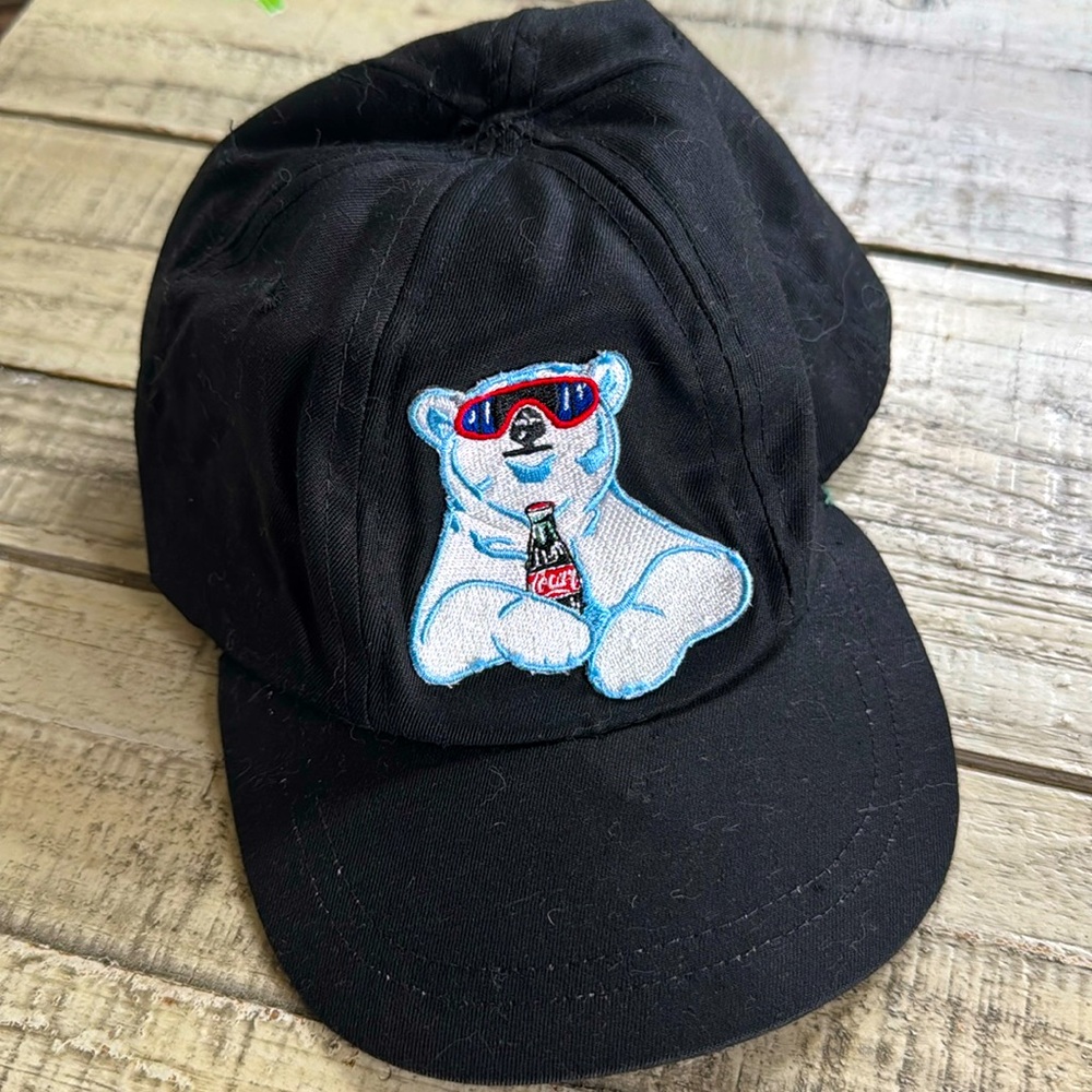 Vintage stock Coco-Cola kids polar bear hat. Black, elastic fitted on back.